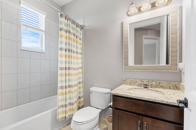 full bathroom with vanity, shower / tub combo with curtain, and toilet