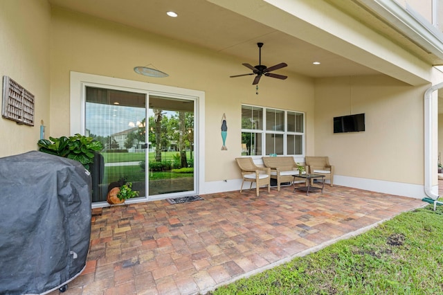 view of patio with outdoor lounge area, a grill, and ceiling fan