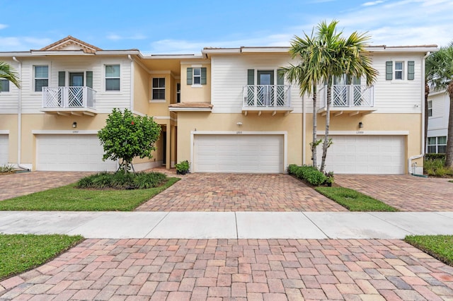 multi unit property featuring a balcony and a garage