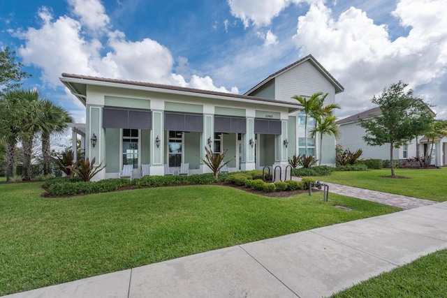 view of front of house featuring covered porch and a front lawn