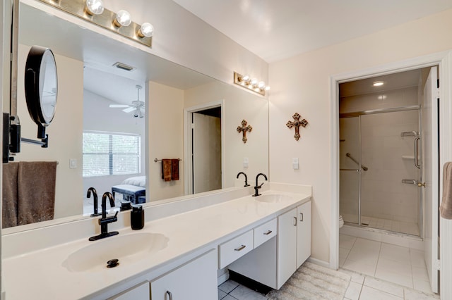 bathroom featuring tile patterned flooring, ceiling fan, an enclosed shower, and vanity