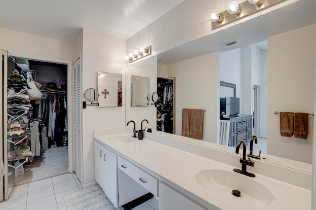 bathroom featuring tile patterned flooring and vanity