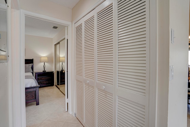 corridor with light tile patterned floors