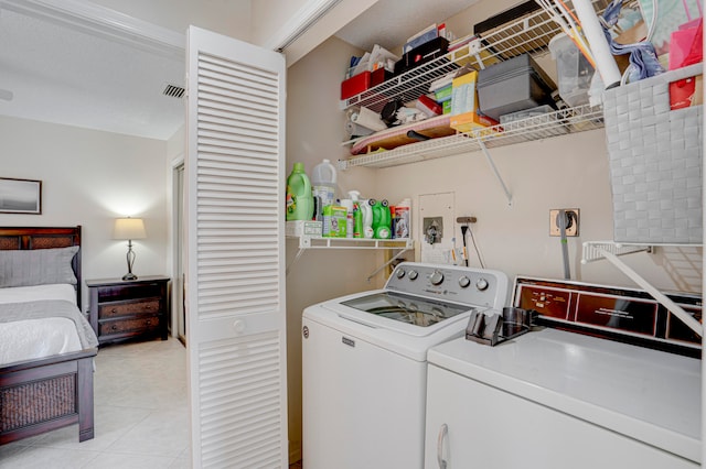 laundry area featuring light tile patterned flooring and independent washer and dryer