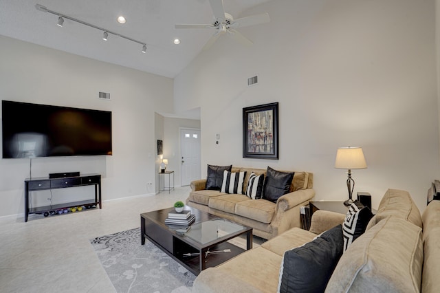 tiled living room featuring rail lighting, high vaulted ceiling, and ceiling fan