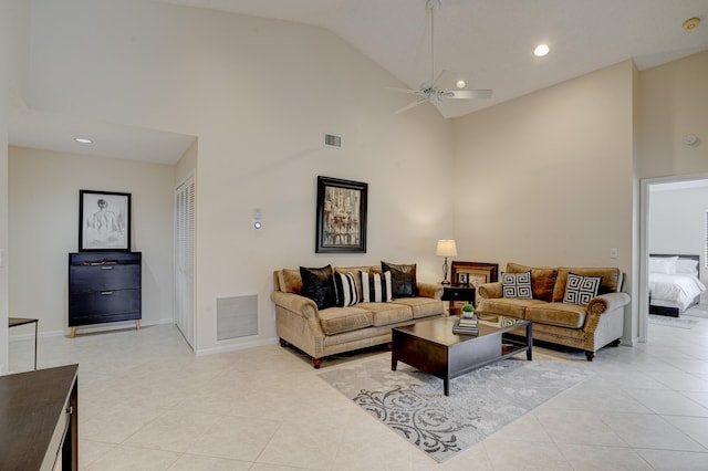 tiled living room with high vaulted ceiling and ceiling fan