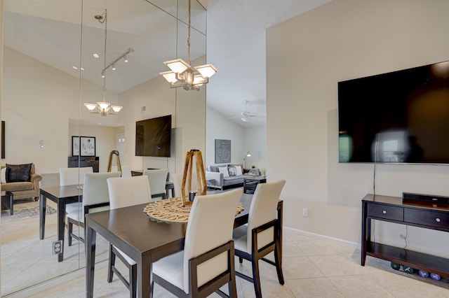 tiled dining space with ceiling fan and high vaulted ceiling