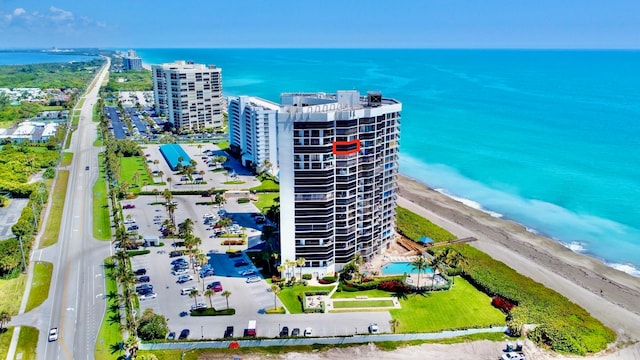 birds eye view of property with a water view and a view of the beach