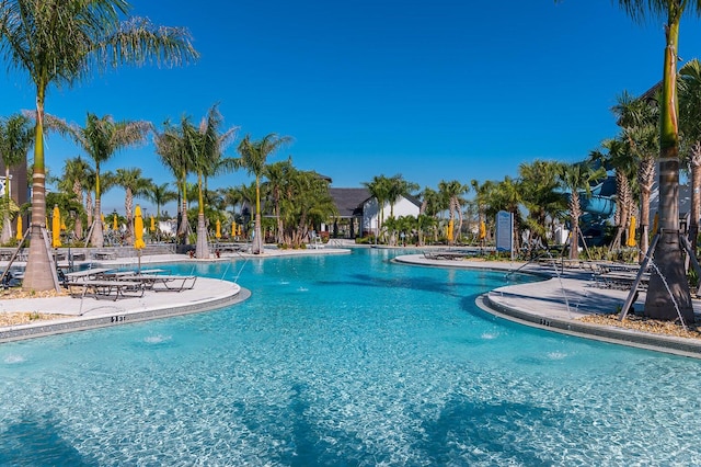 view of swimming pool with pool water feature