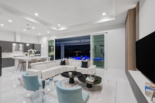 living room featuring ornamental molding and a tray ceiling