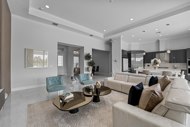 tiled living room featuring ornamental molding and a raised ceiling