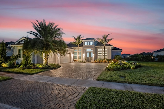 view of front of house featuring a yard and a garage