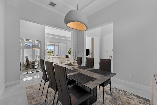 dining space with crown molding and tile patterned flooring