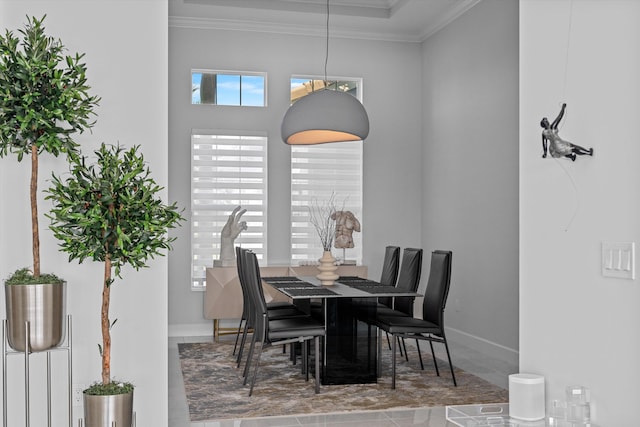 dining space featuring crown molding