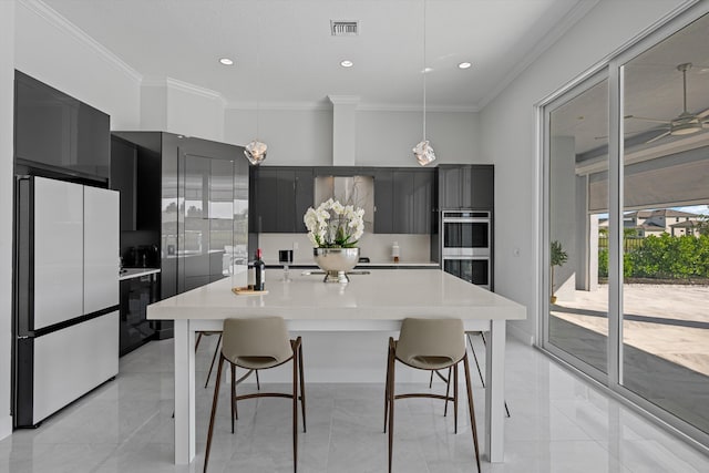 kitchen with stainless steel double oven, decorative light fixtures, ornamental molding, a breakfast bar area, and white refrigerator