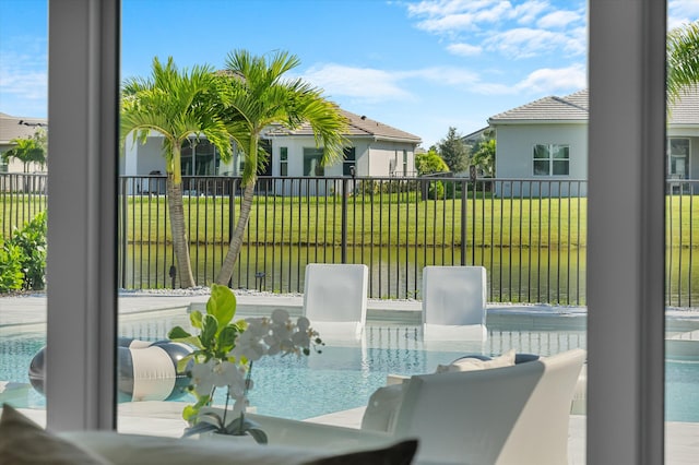 view of patio / terrace with a water view and a fenced in pool