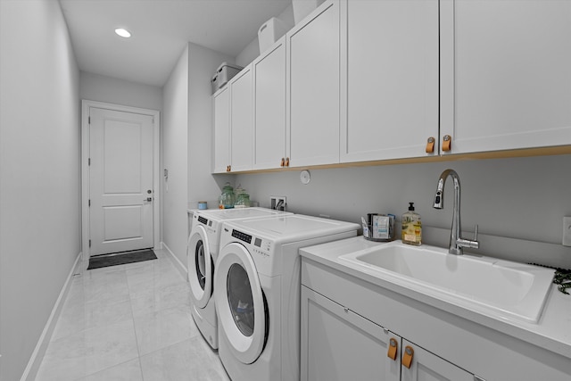 laundry area featuring cabinets, sink, washing machine and dryer, and light tile patterned floors