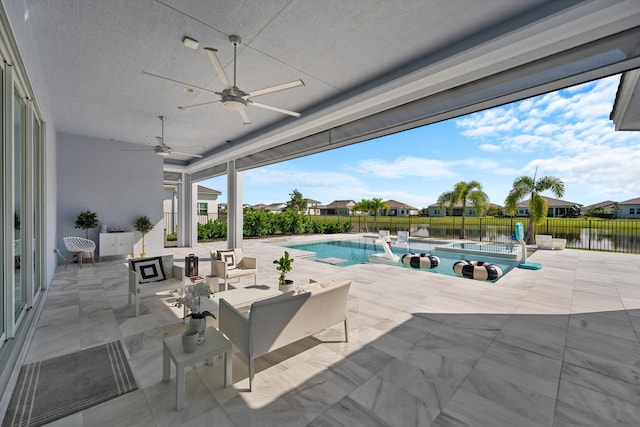 view of pool with a patio, a water view, and ceiling fan