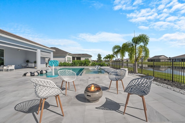 view of pool with a patio and a water view