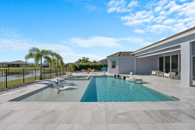 view of pool featuring a water view, a patio area, and an in ground hot tub