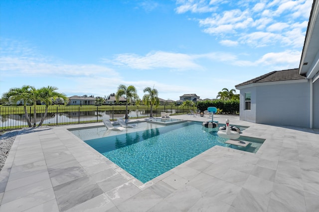 view of swimming pool featuring a patio, a hot tub, and a water view