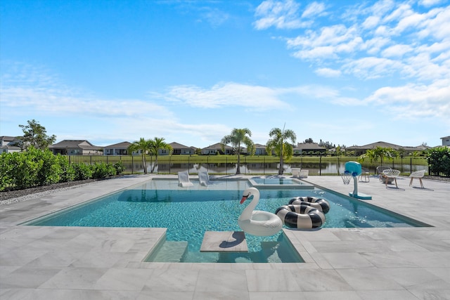 view of swimming pool with a patio area and a water view