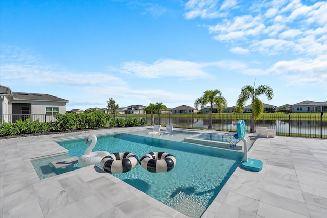 view of pool with a water view and a patio