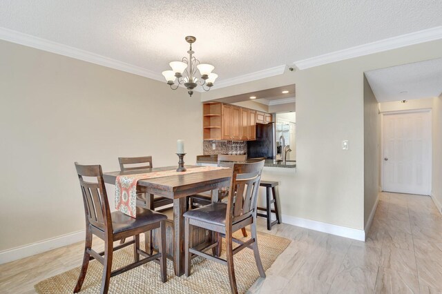 dining space with crown molding, a textured ceiling, and a chandelier