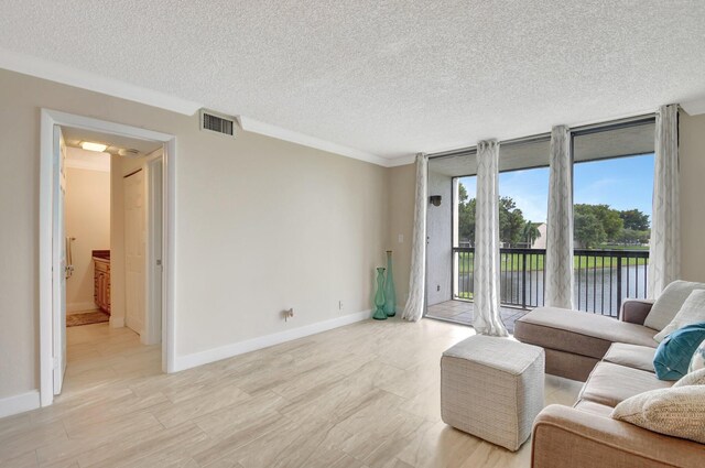 living room with crown molding, a textured ceiling, and a water view