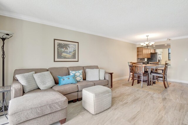 living room featuring crown molding, a notable chandelier, a textured ceiling, and light wood-type flooring