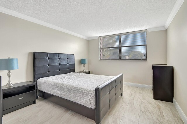 bedroom with light hardwood / wood-style floors, crown molding, and a textured ceiling