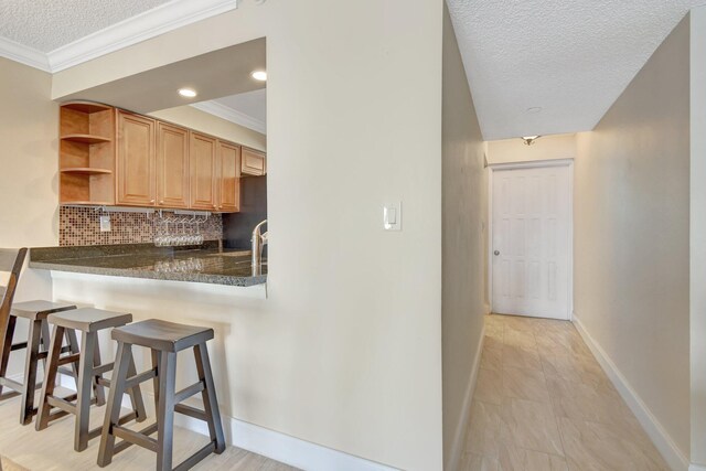 unfurnished bedroom with ornamental molding, a textured ceiling, and a closet