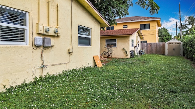 view of home's exterior featuring a yard and a shed