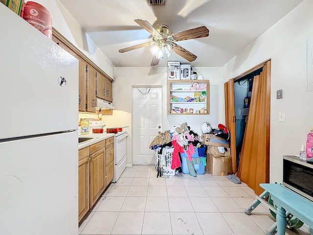 kitchen featuring white appliances, ceiling fan, light tile patterned floors, and sink