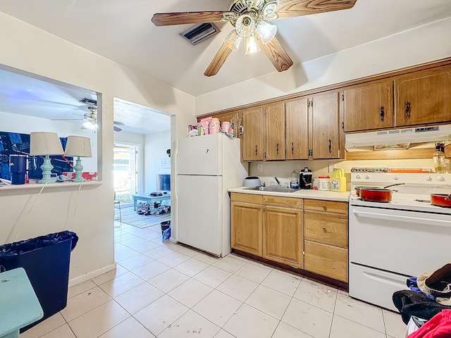 kitchen with white appliances, light tile patterned floors, and sink