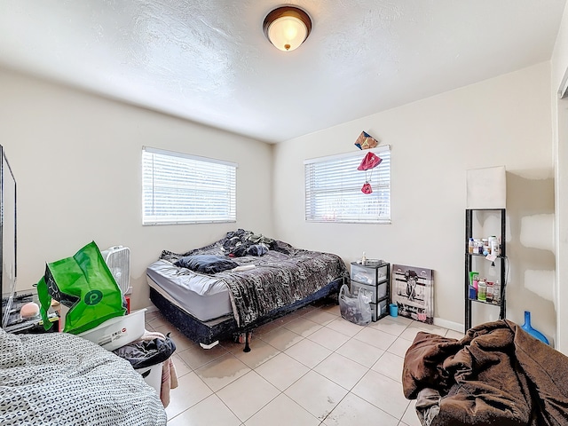 bedroom with light tile patterned floors