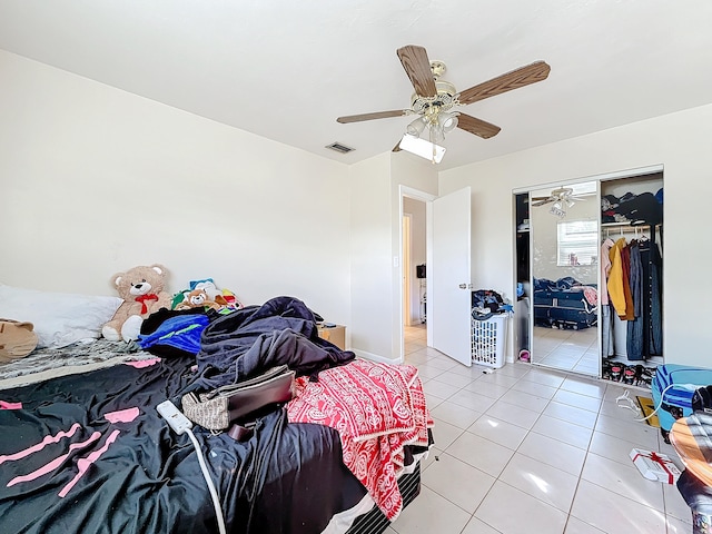 bedroom featuring a closet, light tile patterned floors, and ceiling fan