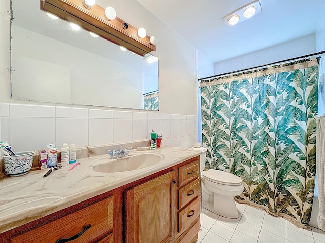 bathroom featuring vanity, toilet, tile walls, and tile patterned flooring