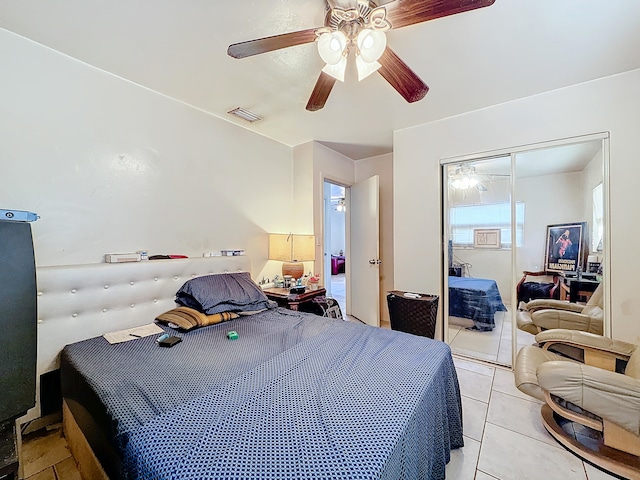 tiled bedroom with a closet and ceiling fan