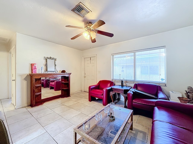 tiled living room with ceiling fan