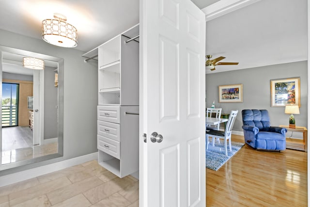 spacious closet featuring ceiling fan and light wood-type flooring