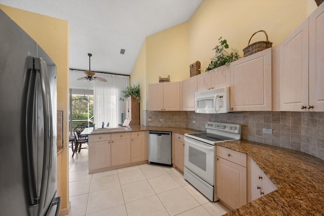 kitchen featuring light brown cabinetry, tasteful backsplash, stainless steel appliances, ceiling fan, and light tile patterned flooring