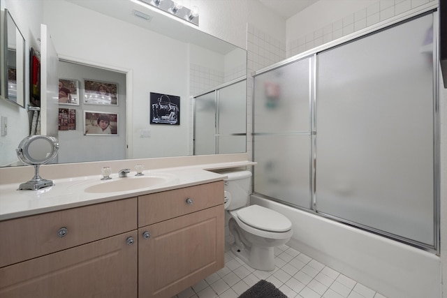 full bathroom with tile patterned flooring, vanity, toilet, and enclosed tub / shower combo