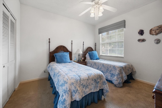 carpeted bedroom with a closet and ceiling fan