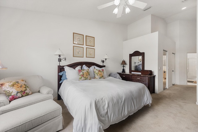 bedroom featuring connected bathroom, ceiling fan, high vaulted ceiling, and light carpet