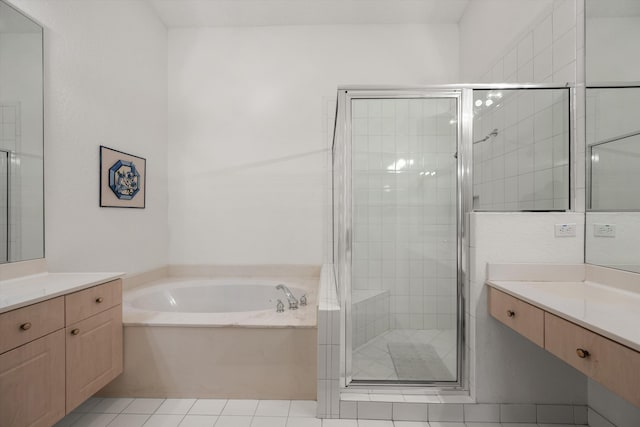 bathroom featuring tile patterned flooring, vanity, and plus walk in shower