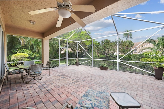 view of patio featuring a lanai and ceiling fan