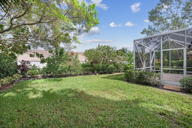 view of yard with glass enclosure