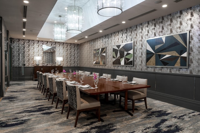 dining space featuring hardwood / wood-style flooring and a notable chandelier