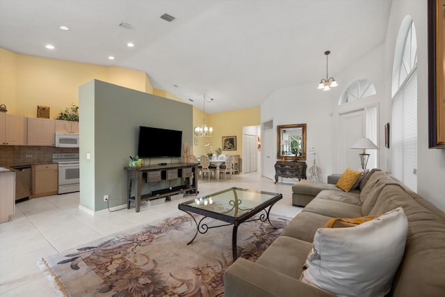 living room with light tile patterned floors, a healthy amount of sunlight, and an inviting chandelier